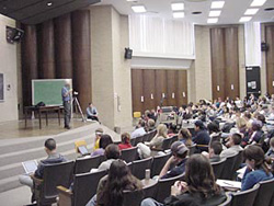 photograph of Ronald Takaki addressing an auditorium of students