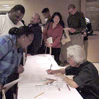 photograph of Ronald Takaki at table during book signing