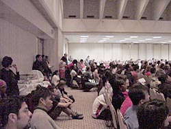photograph of standing room only crowd listening to Ronald Takaki