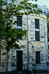 a photograph of a two storey jail constructed of limestone